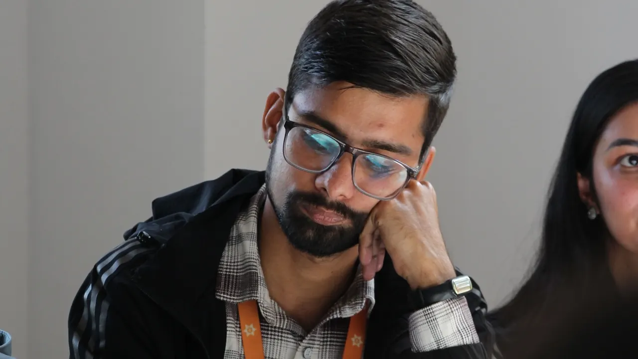 Student focused on notes at a desk